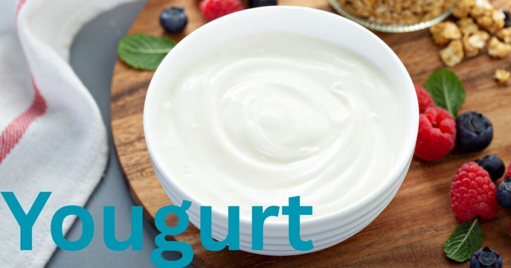 A bowl or cup of creamy white yogurt with a smooth, thick consistency.