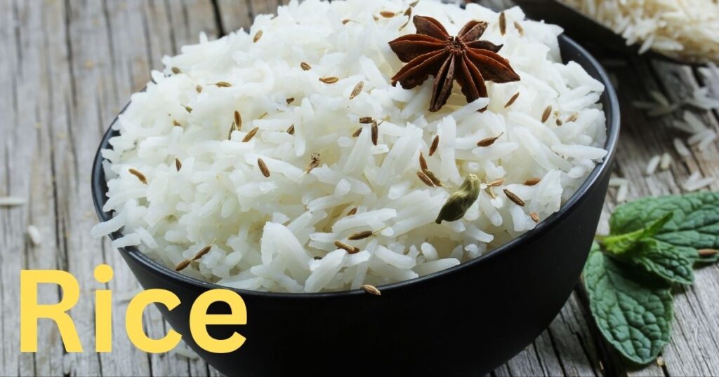A portion of cooked white or brown rice showing individual grains with a fluffy appearance.